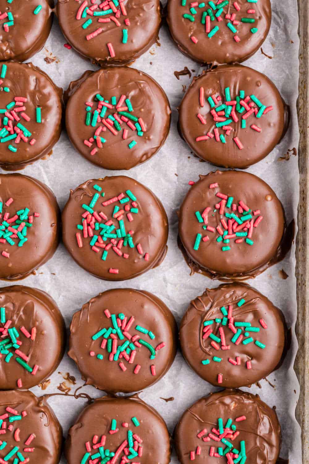 Ritz cracker cookies on a parchment lined baking sheet