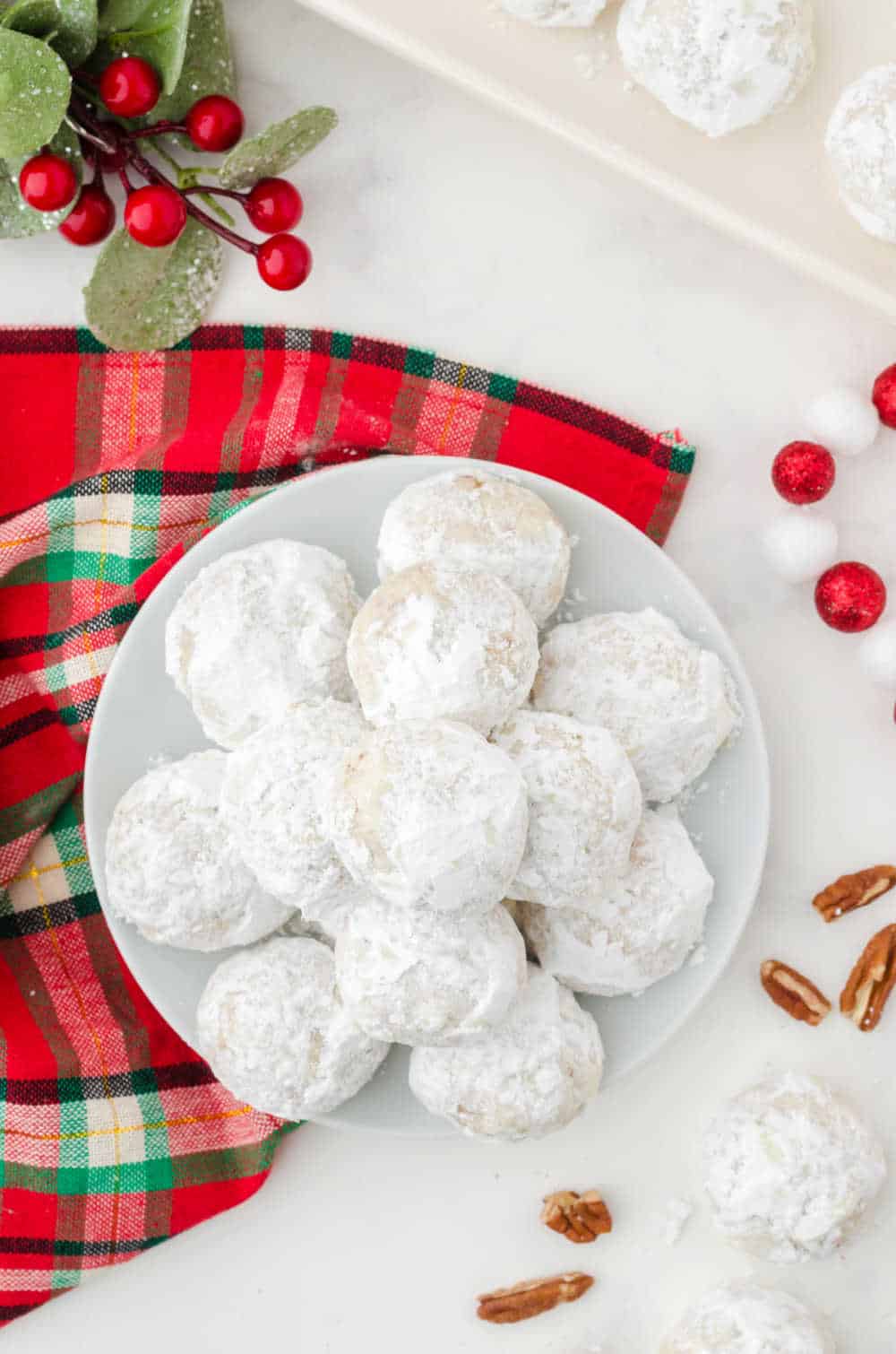 snowball cookies on a white plate