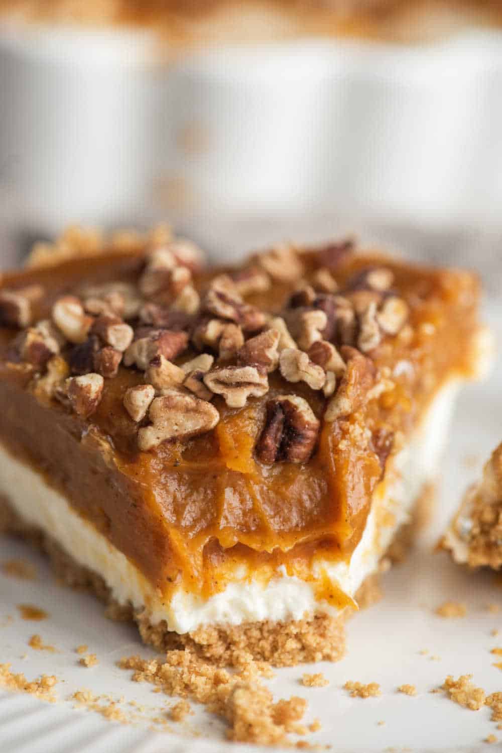 A slice of pumpkin pie cheesecake with a bite out of the end