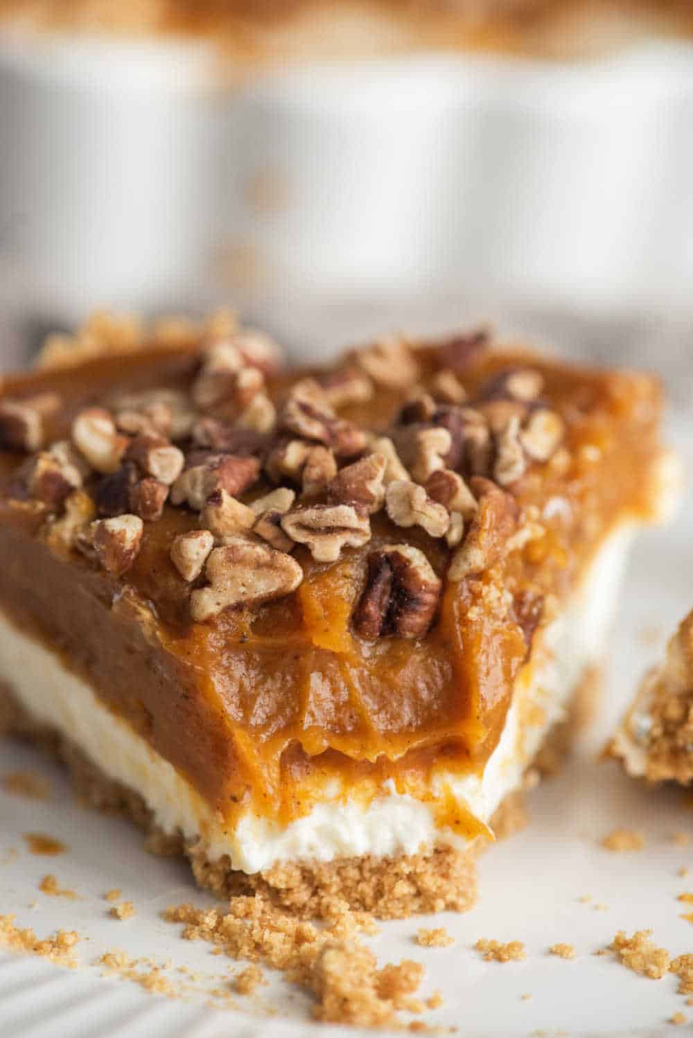 A slice of pumpkin pie cheesecake with a bite out of the end