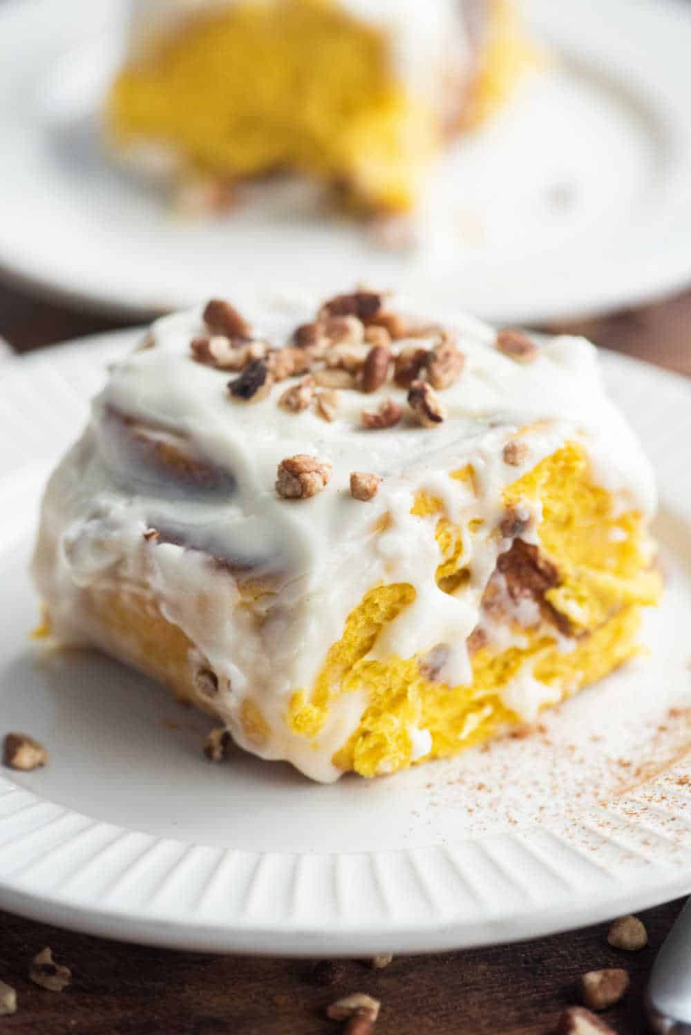 pumpkin cinnamon roll on a white plate