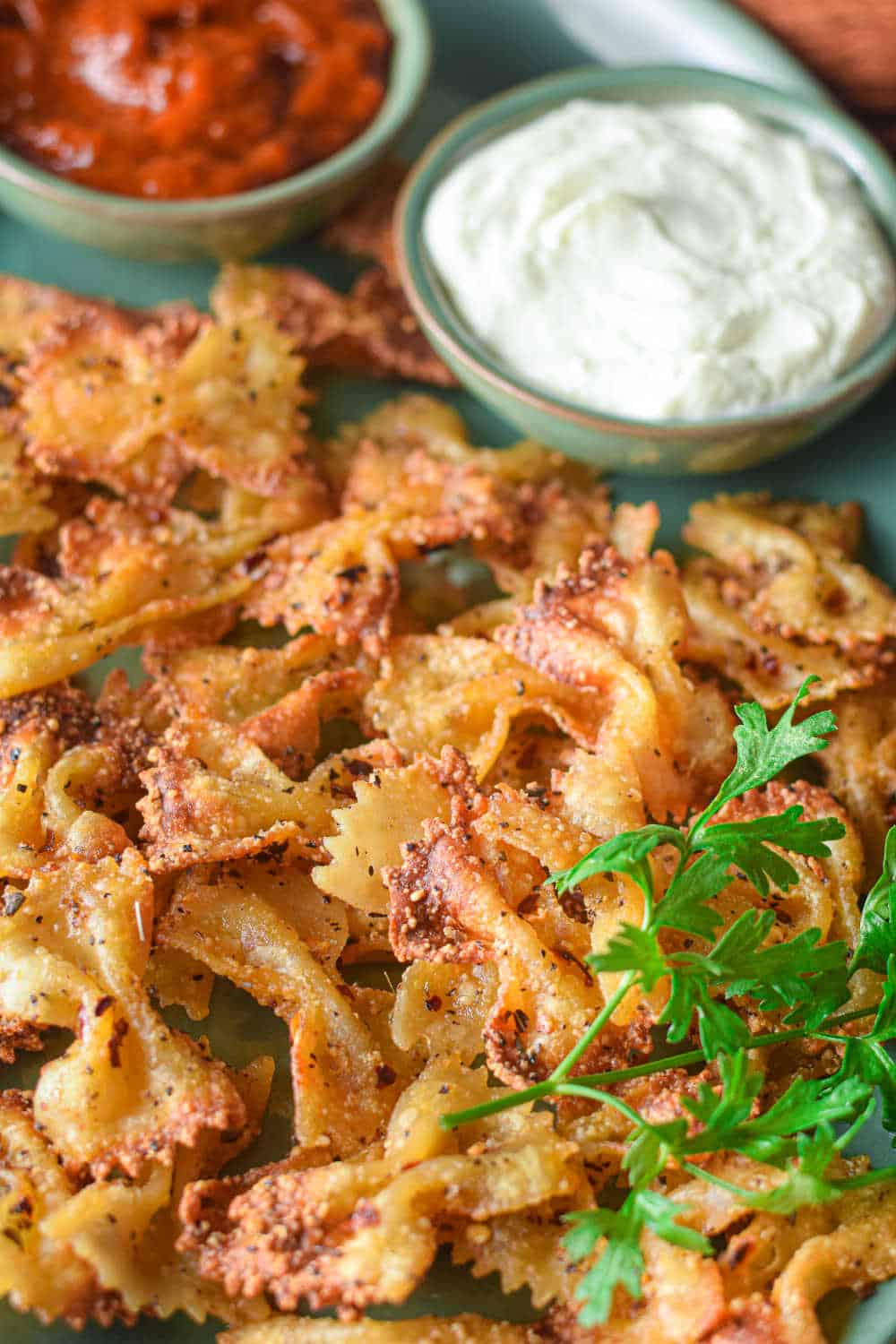 air fryer pasta chips on a platter with dip