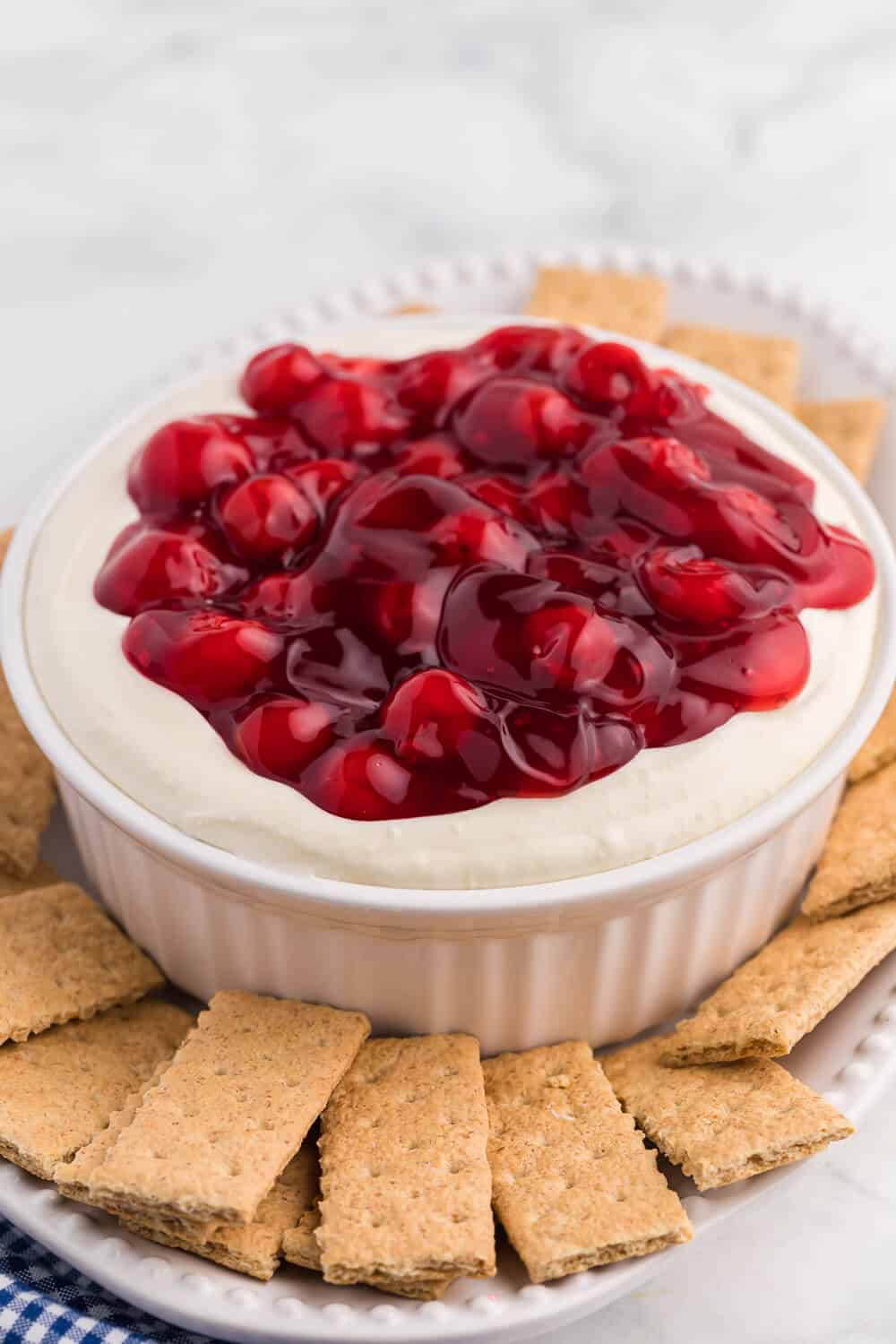 cherry cheesecake dip on a platter with graham crackers