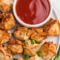 The recipe on a white plate with sweet and sour sauce.