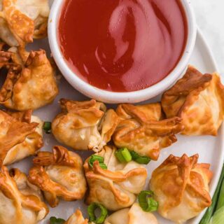 The recipe on a white plate with sweet and sour sauce.