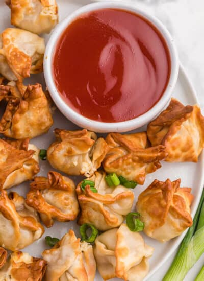 The recipe on a white plate with sweet and sour sauce.