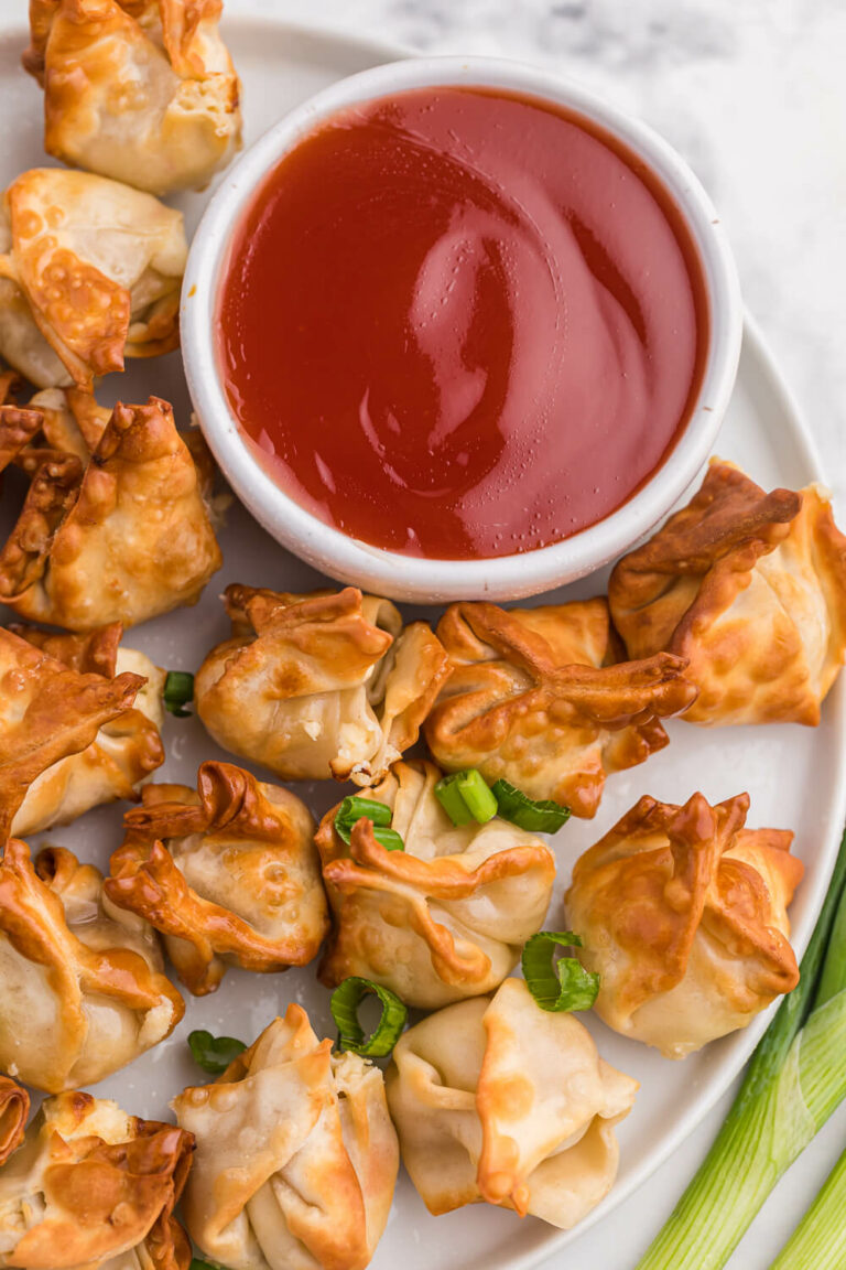 The recipe on a white plate with sweet and sour sauce.
