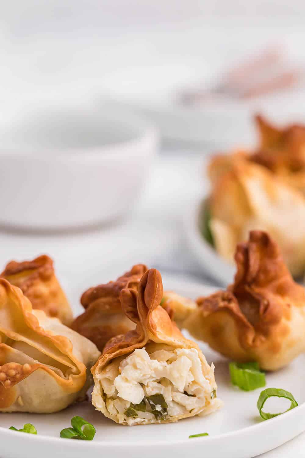 an air fryer crab rangoon cut in half showing inside