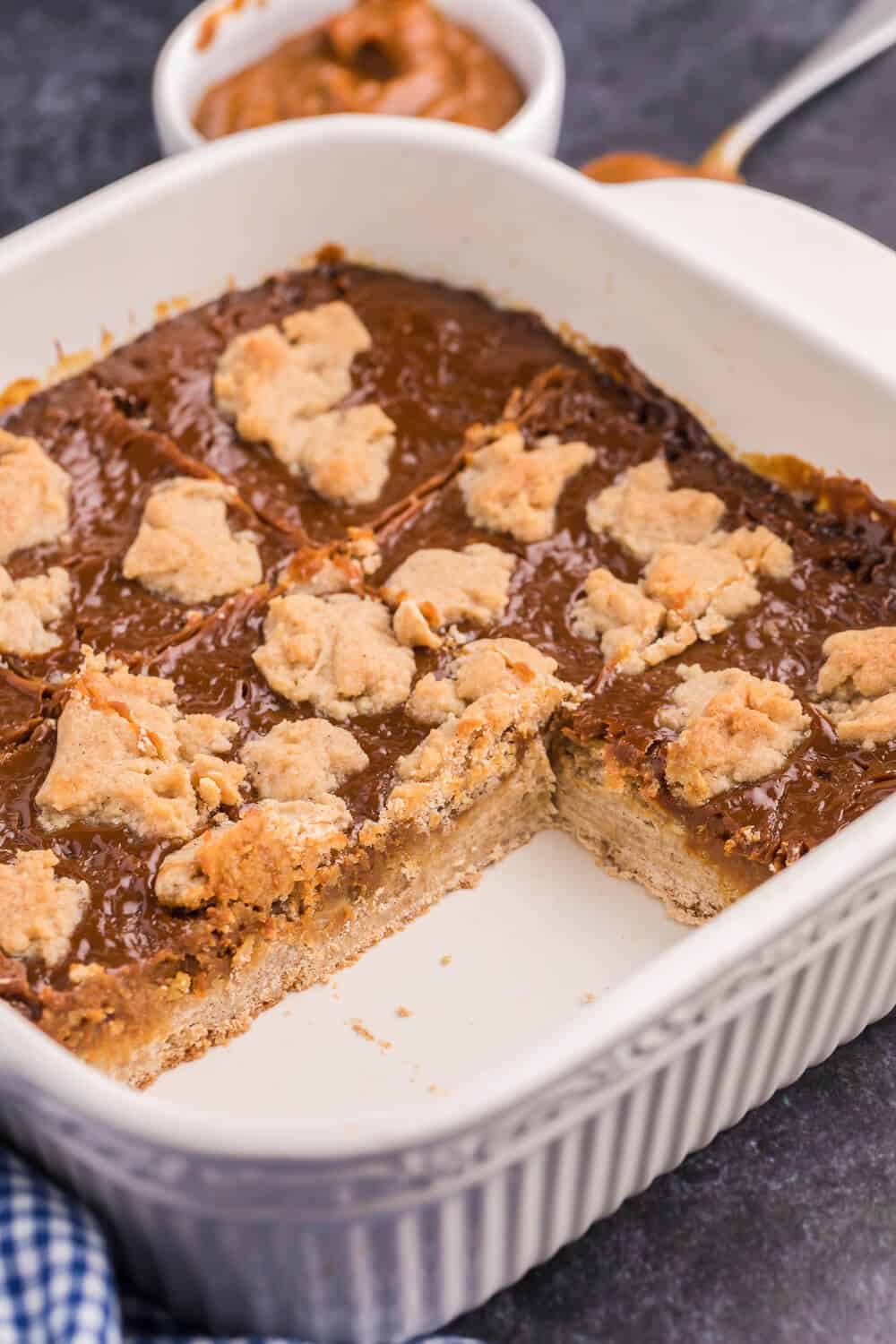 Dulce de Leche bars in the baking pan with a few pieces removed.