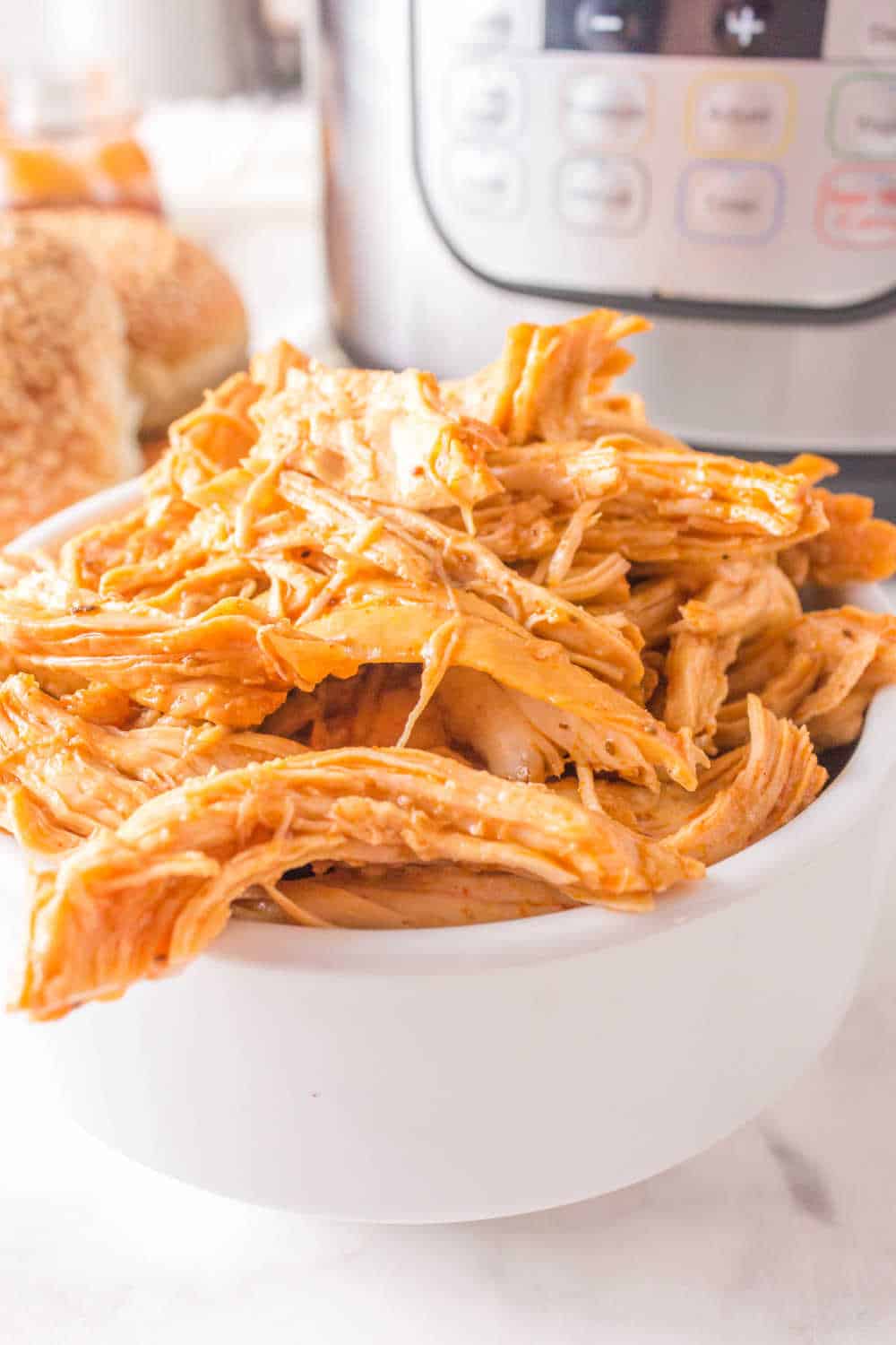 instant pot bbq shredded chicken in a white bowl