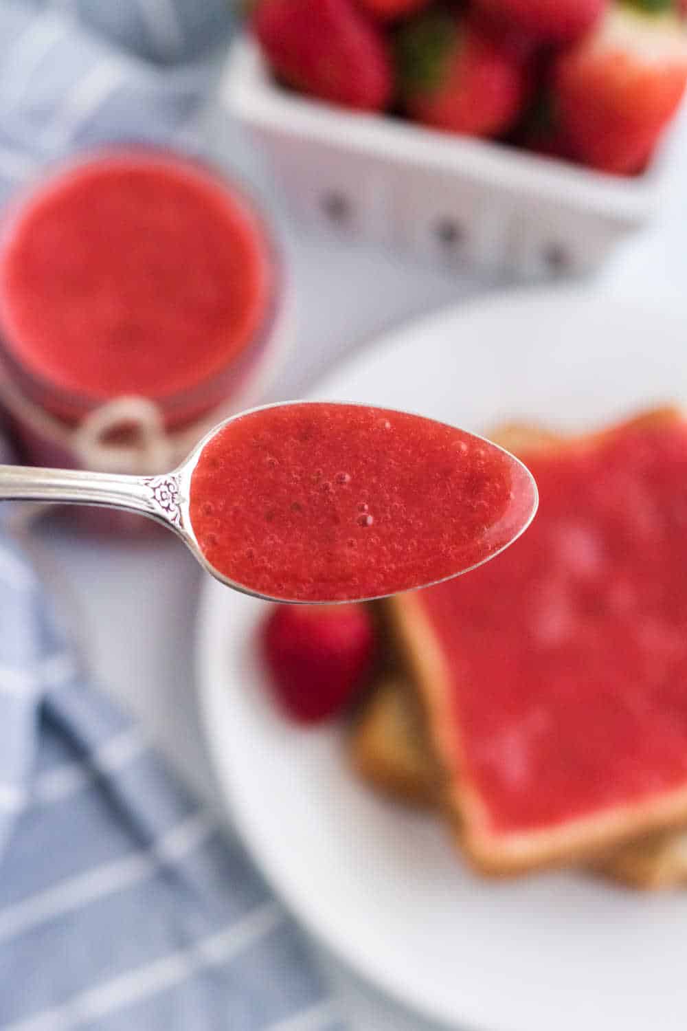 Instant Pot strawberry jam on a spoon.