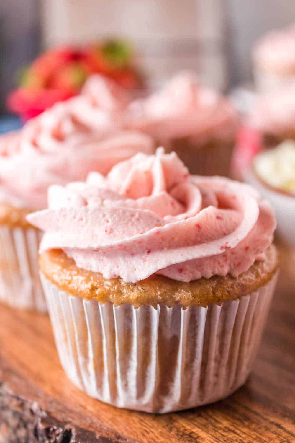 strawberry cupcake on a wooden platter