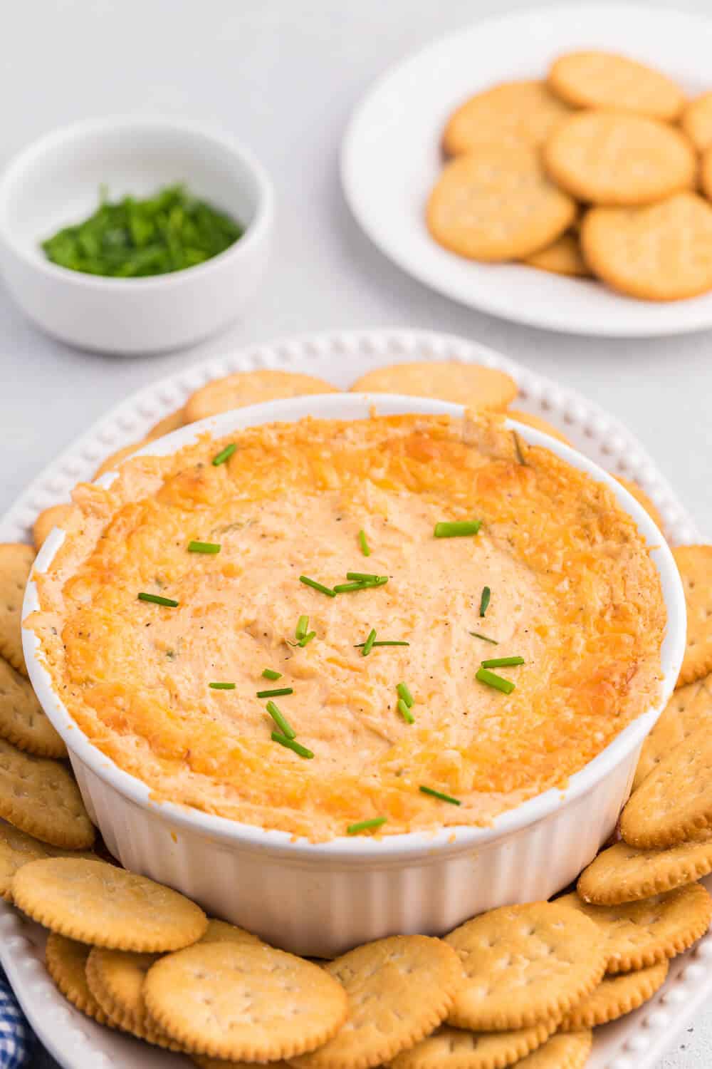 Crab dip on a platter with Ritz crackers.