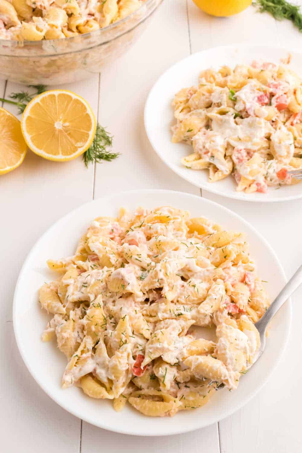A plate of shrimp pasta salad with a fork.