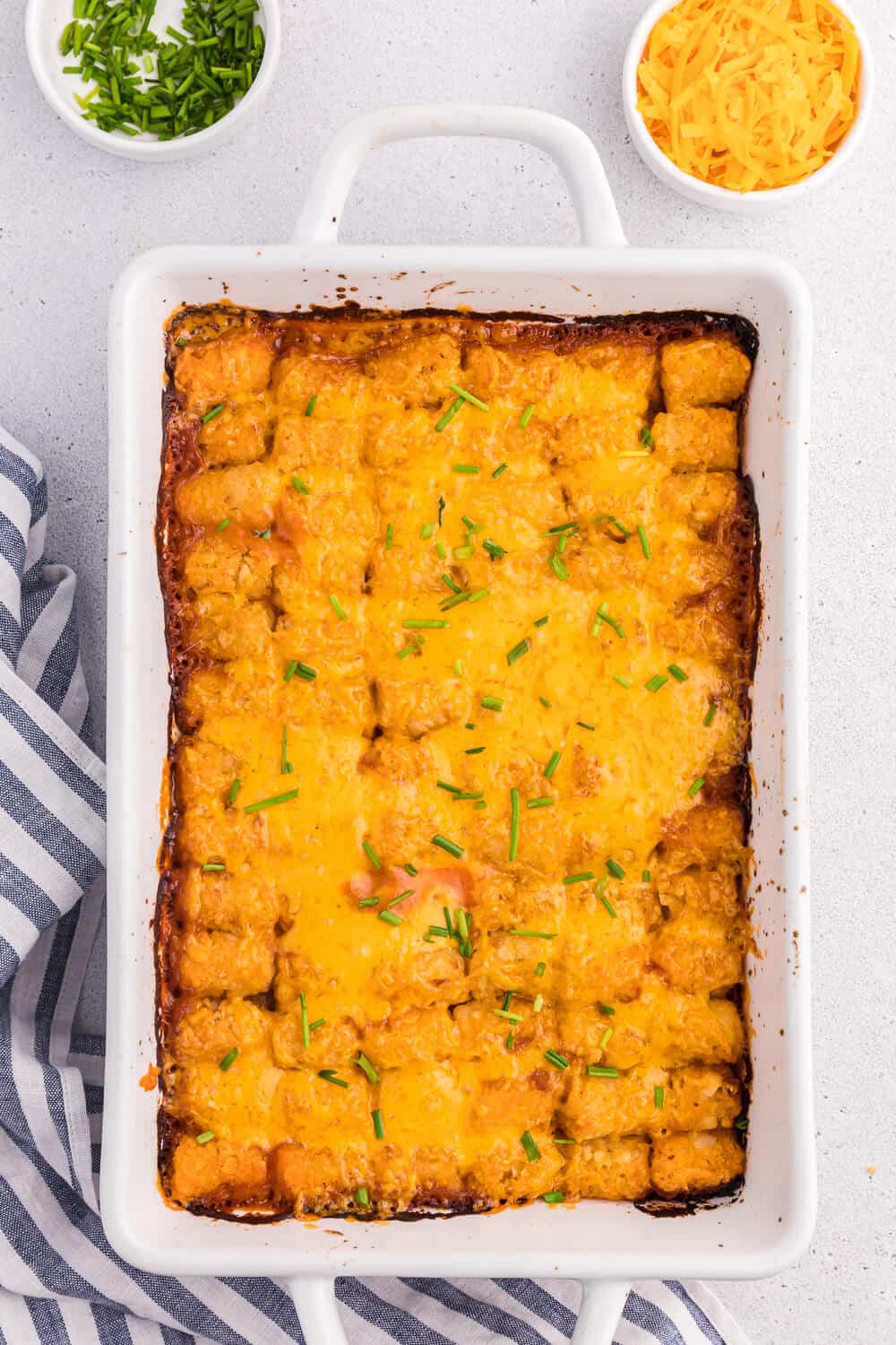 Sloppy joe tater tot casserole in a white casserole dish.