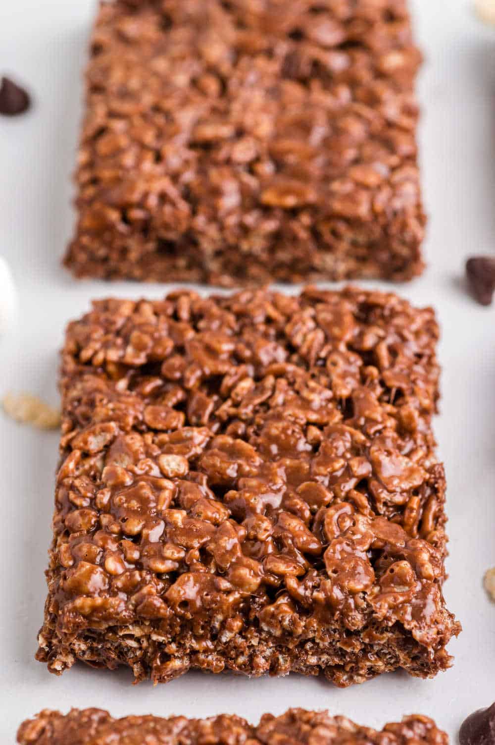 chocolate rice krispie squares on a white surface.