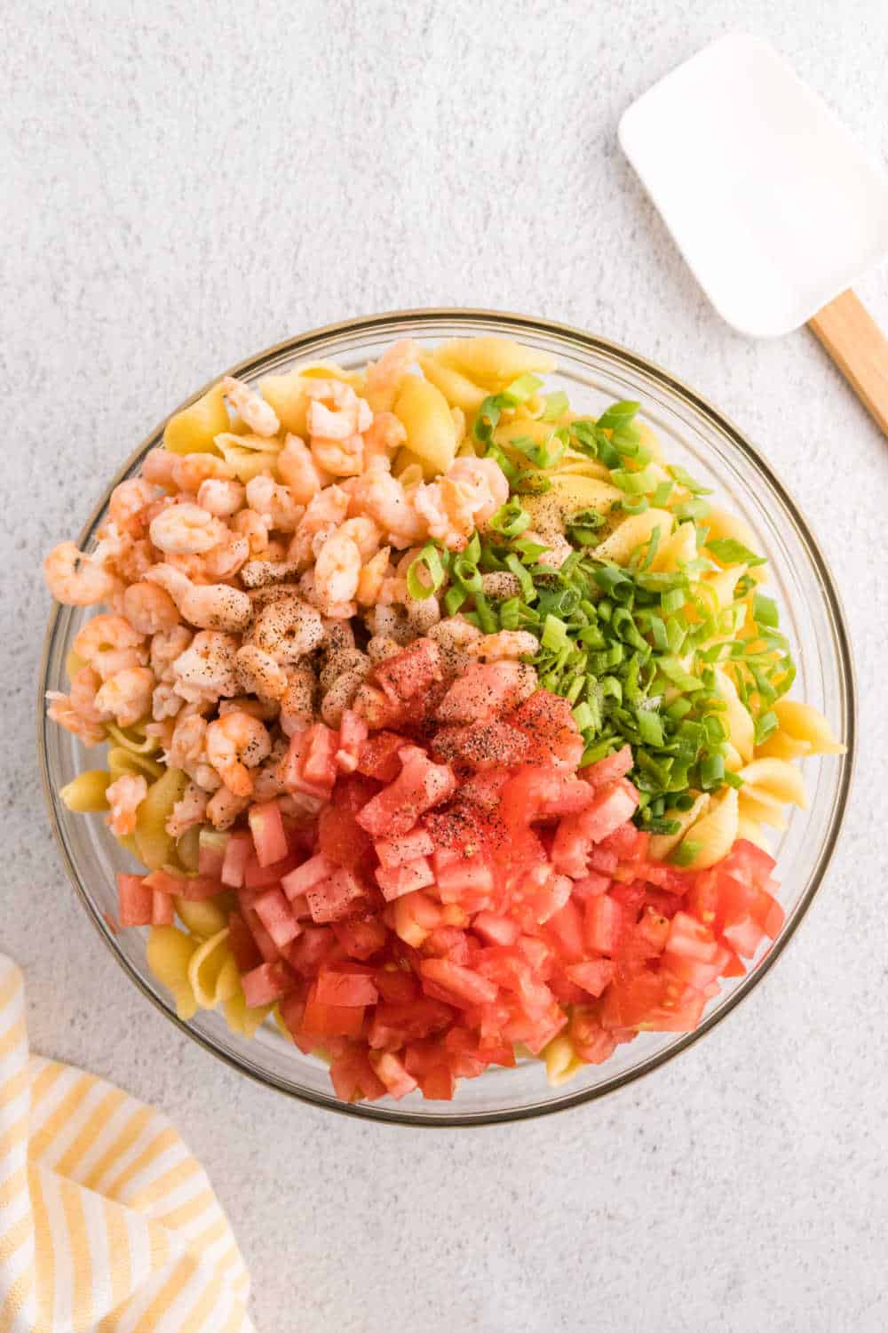 Shrimp pasta salad ingredients in a mixing bowl.