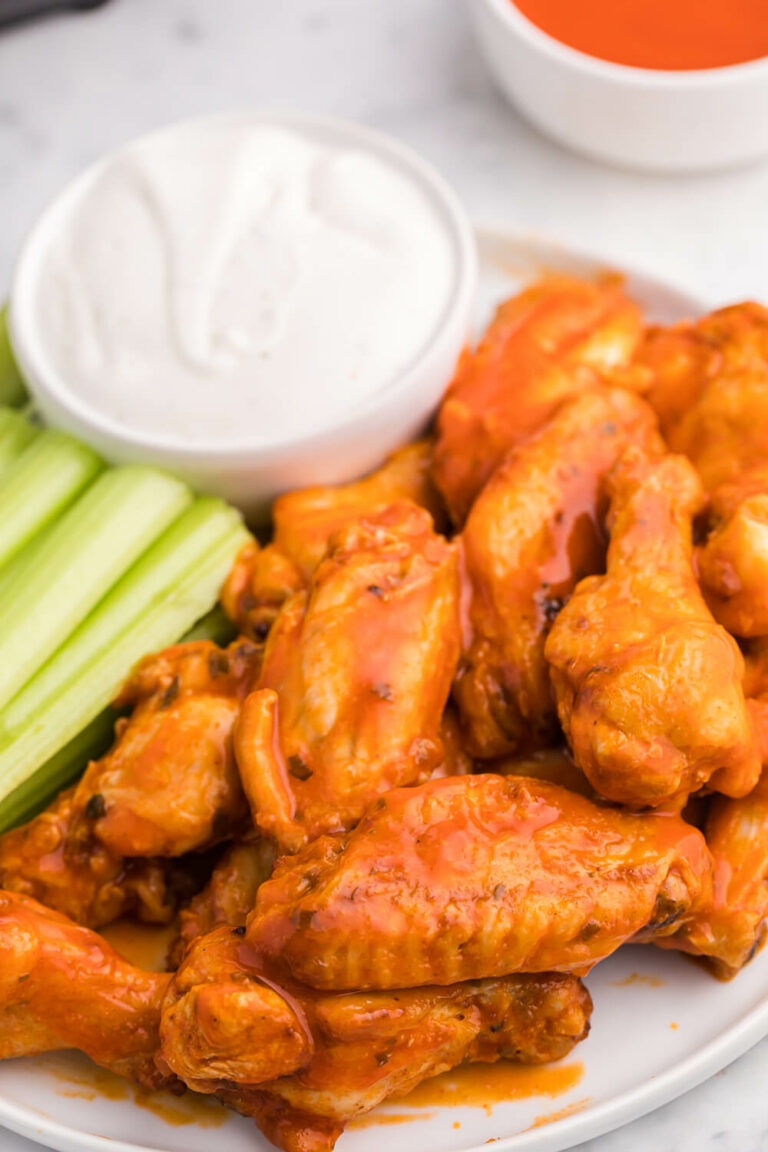 The recipe on a plate with celery sticks and ranch dip.