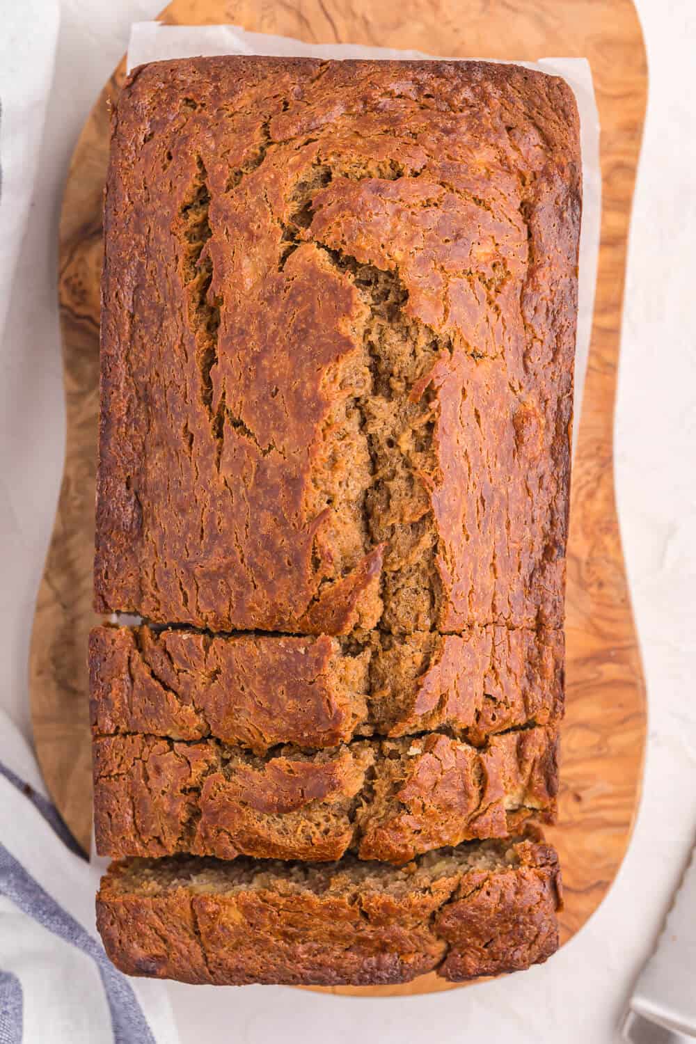 A loaf of banana bread on a wooden surface.