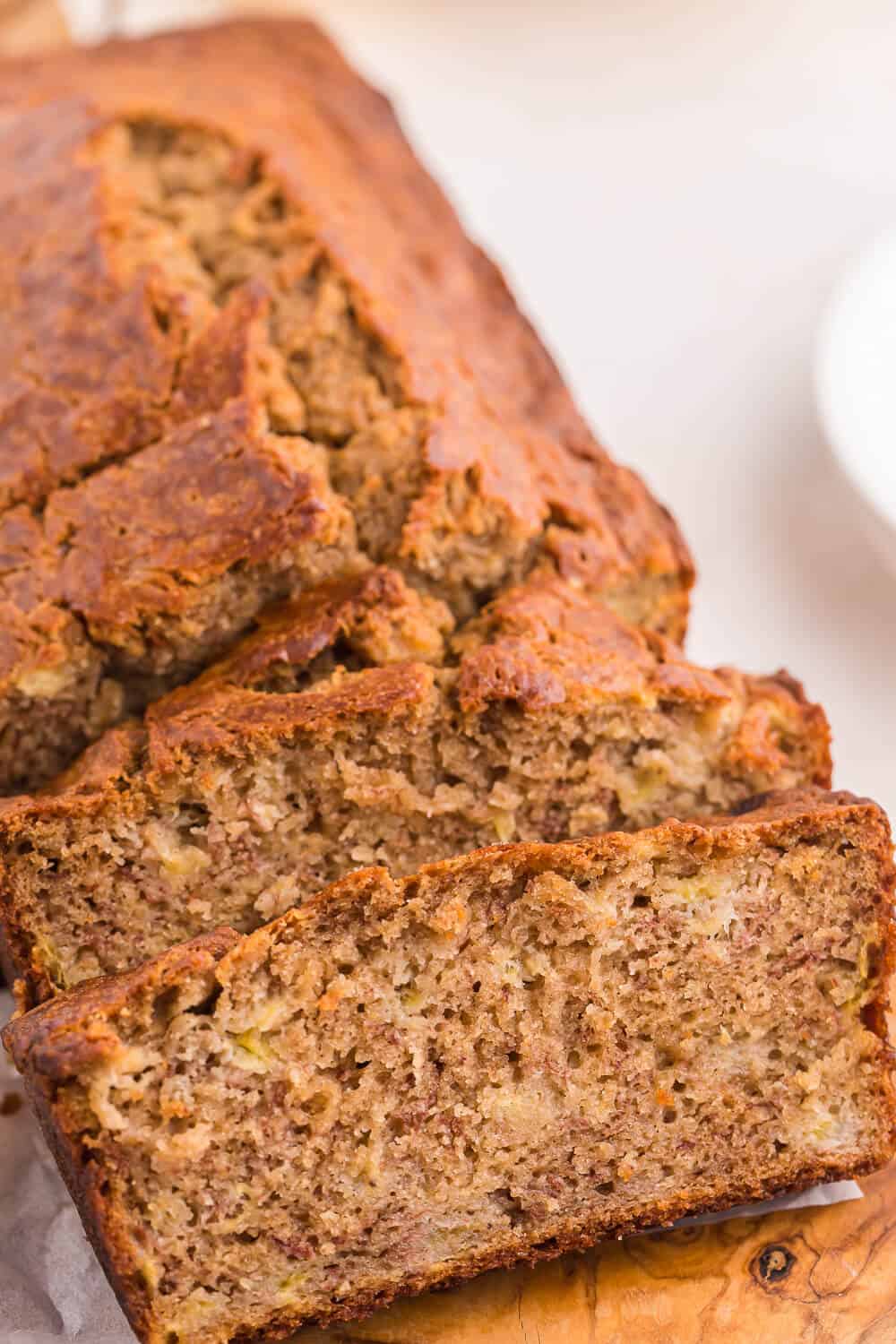 Banana bread with slices cut at the end.