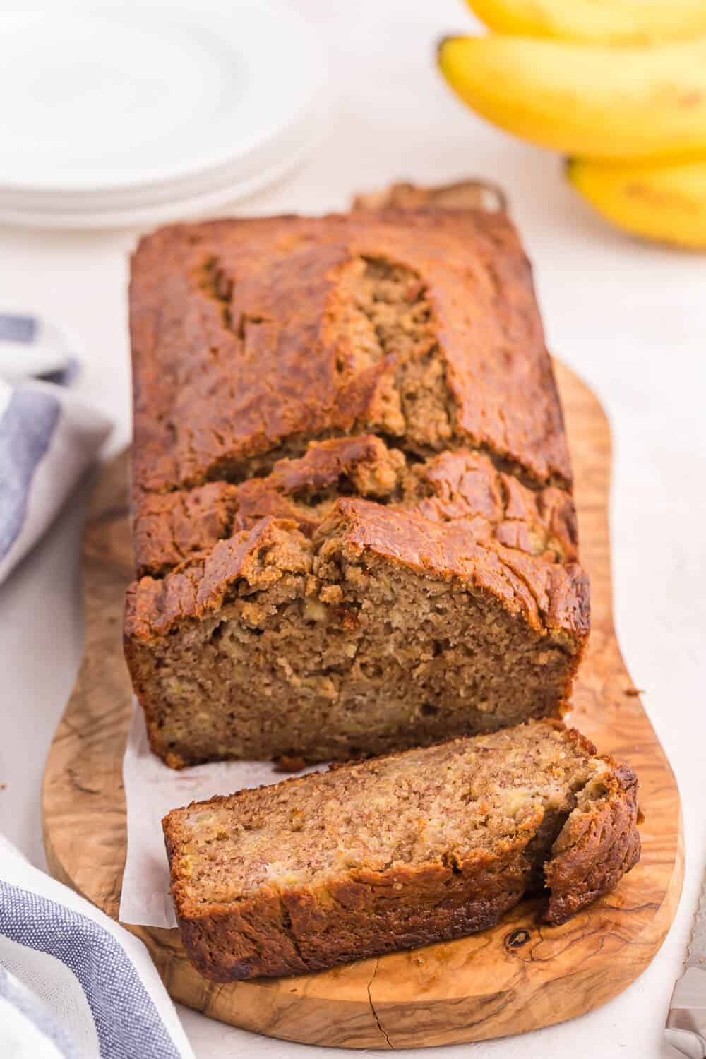 Banana bread with slices cut at the end.