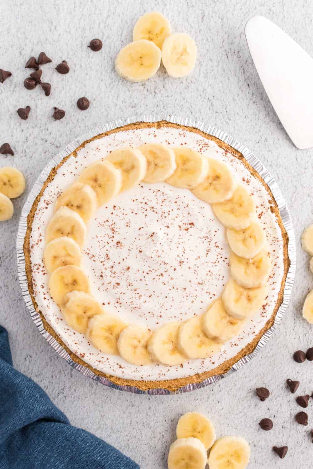 Black bottom banana cream pie on grey surface.