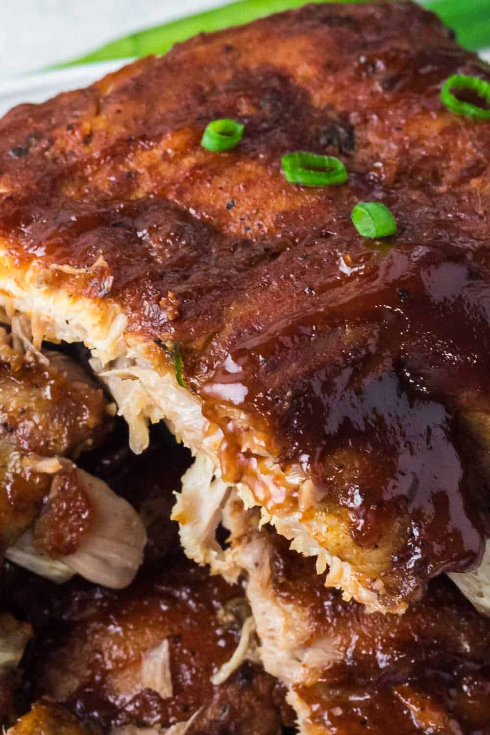 Instant Pot BBQ Pork Ribs stacked on a plate.