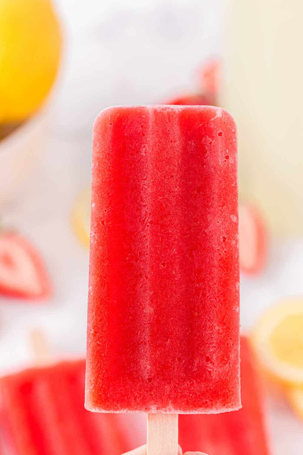 A single strawberry lemonade popsicle.
