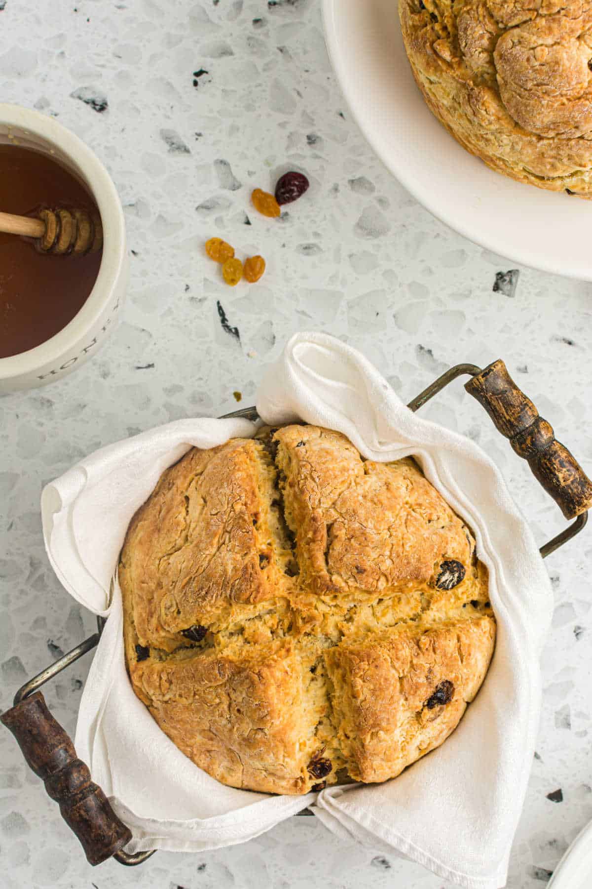 Air fryer Irish soda bread in a pan with a white linen.