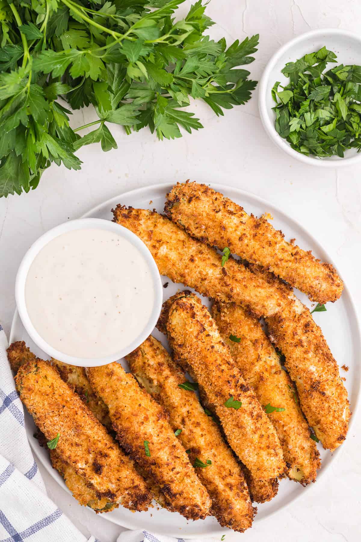 A plate of fried pickles with ranch dressing.