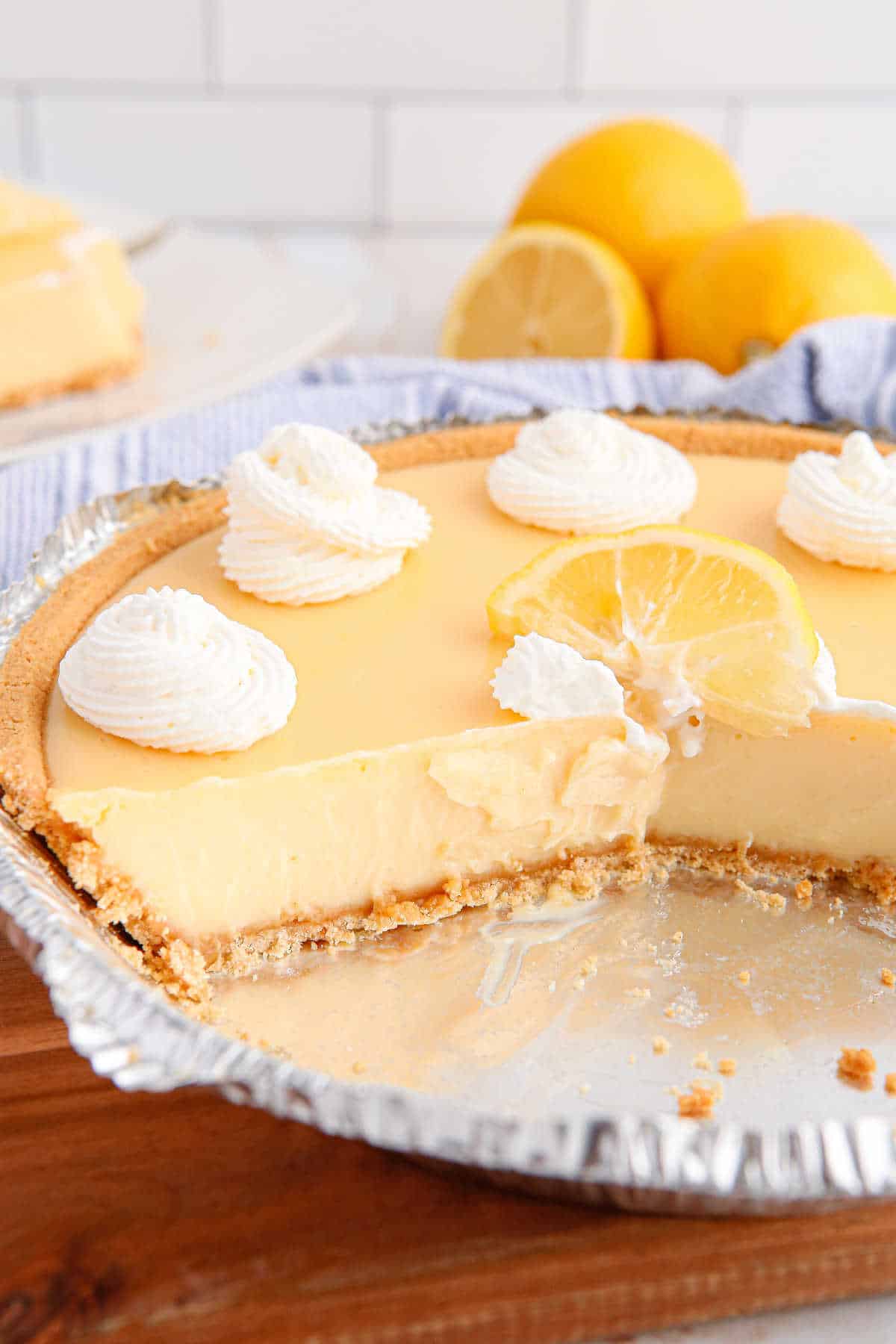 Classic lemon pie with slices cut out.