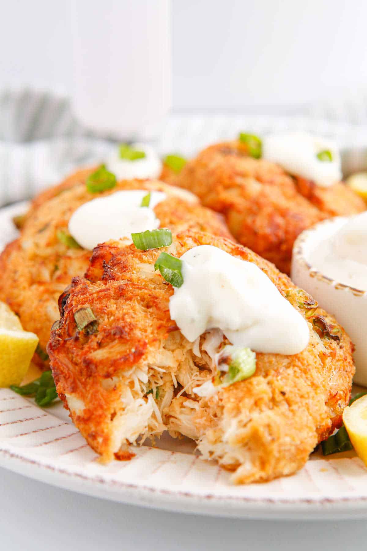 Air fryer crab cakes with a bite out of one.