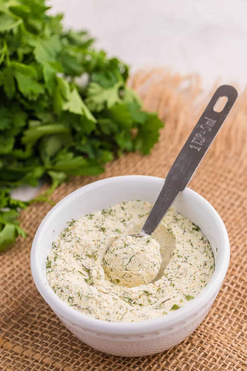 Ranch seasoning in a small bowl with a measuring spoon.