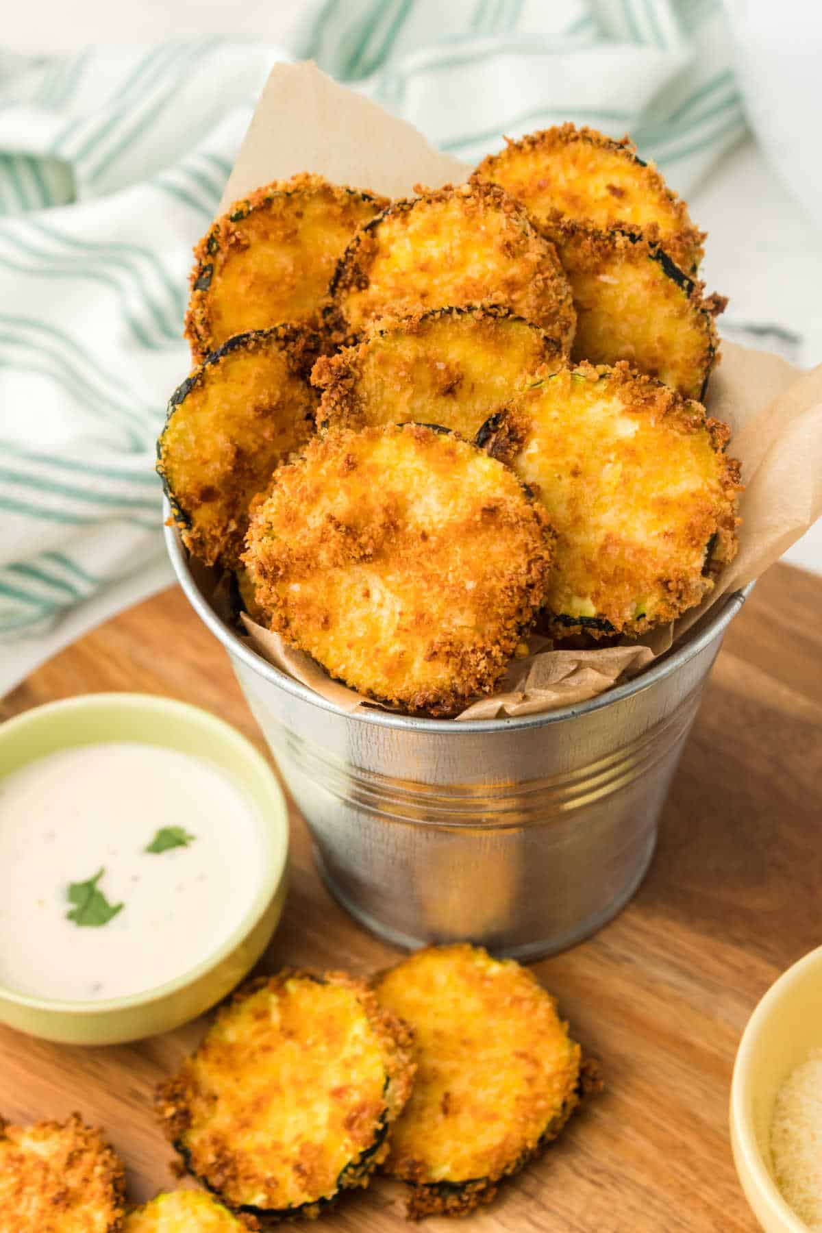 A metal tin with air fryer zucchini chips.