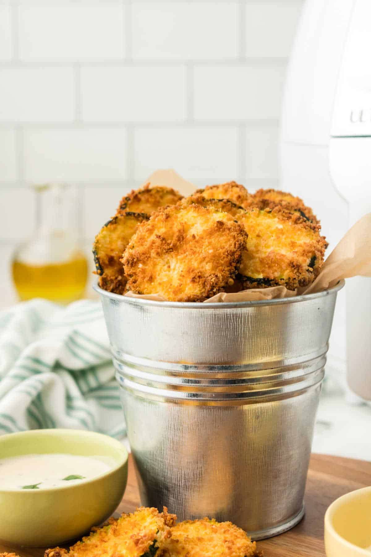 A metal tin with air fryer zucchini chips.