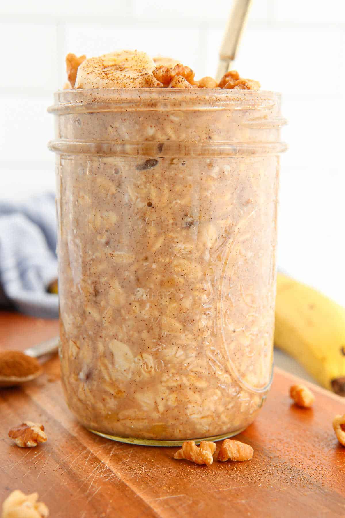 Banana bread overnight oats in a mason jar with a spoon.
