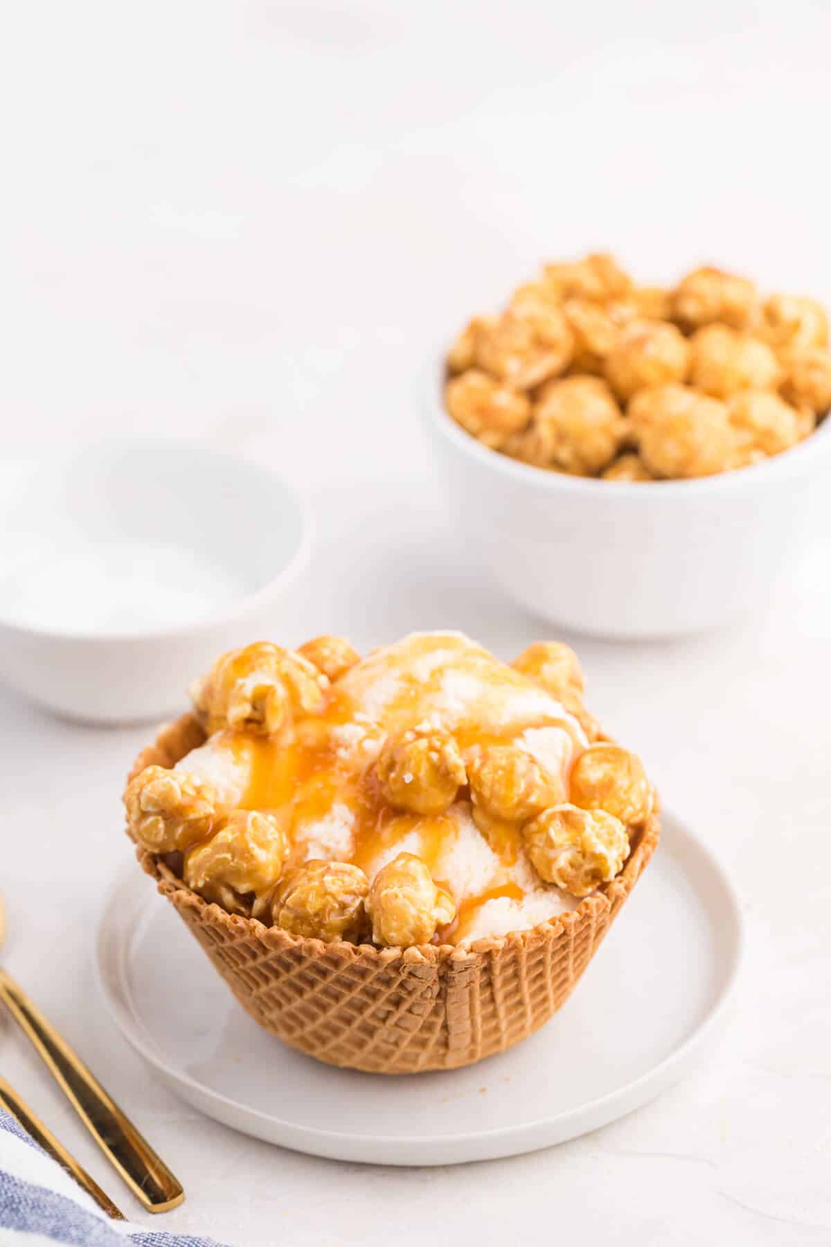 Caramel crunch ice cream sundae on a plate.