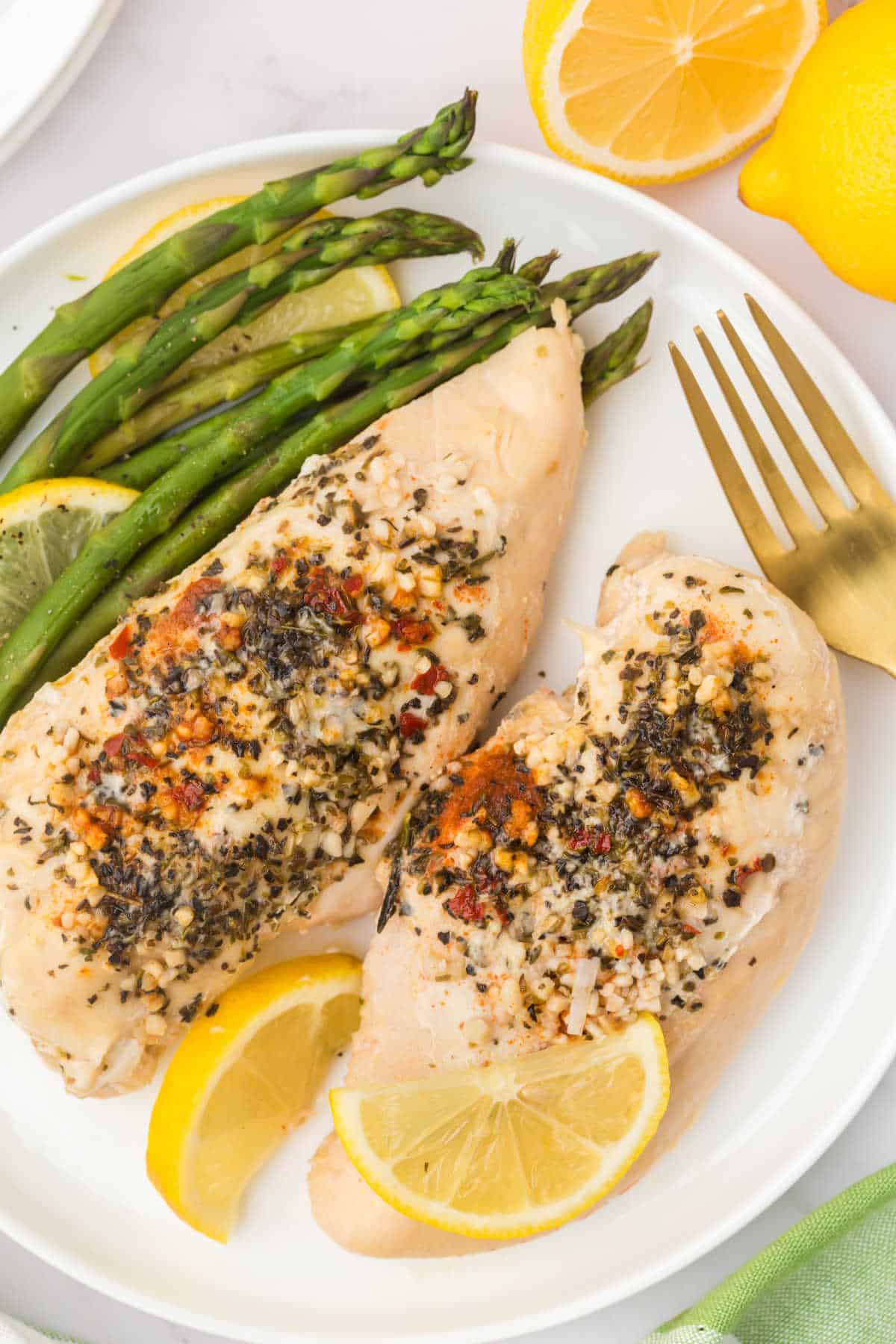 Lemon Garlic butter chicken on a plate with asparagus.