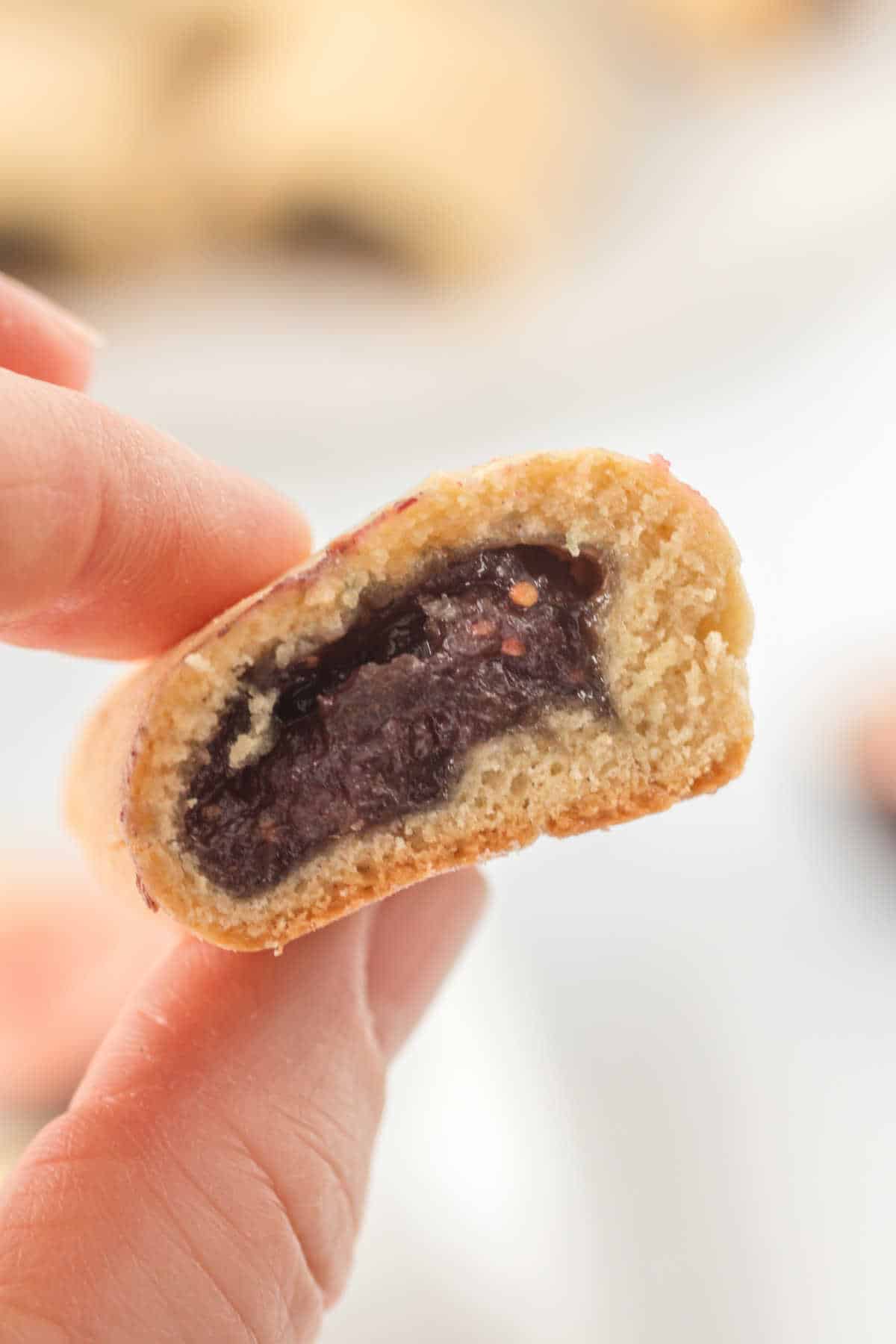 A hand holding a cookie.