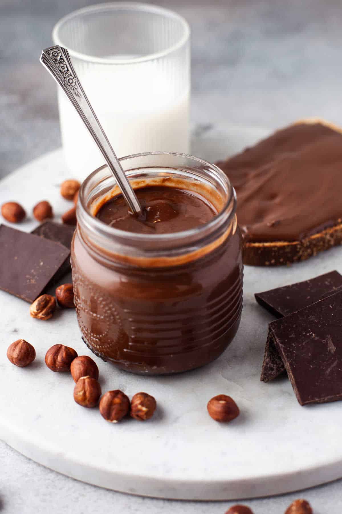 Homemade nutella in a jar with a spoon.