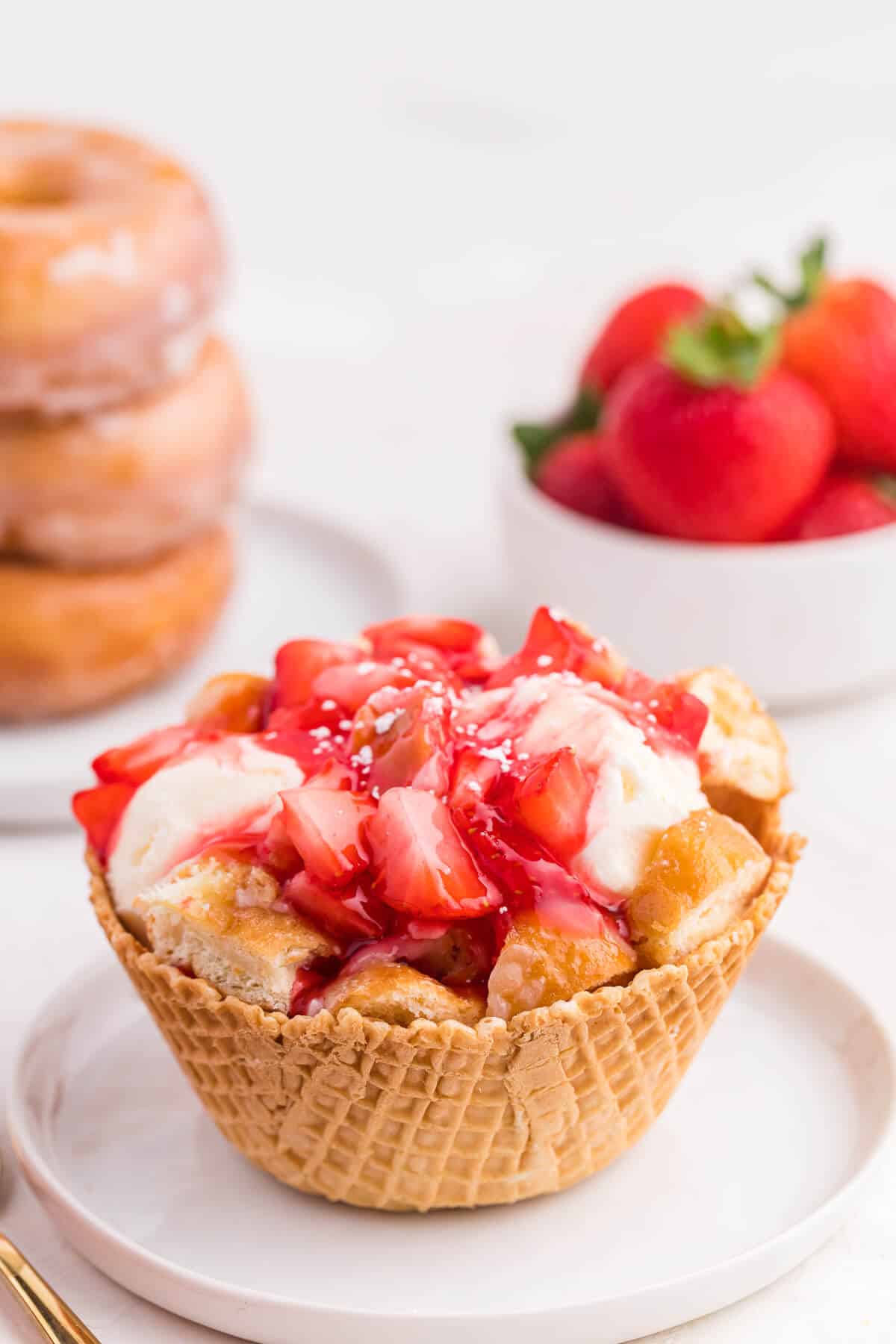 Jelly donut ice cream bowl on a plate.