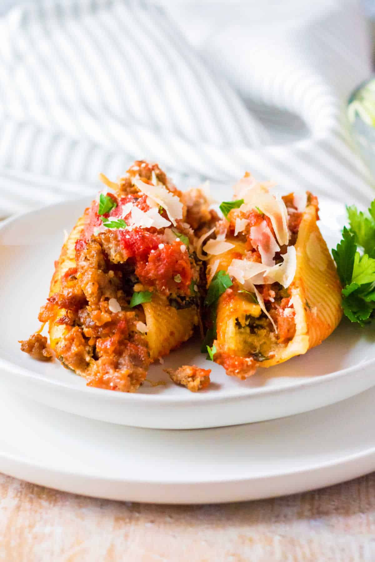 Stuffed shells served on a white plate.