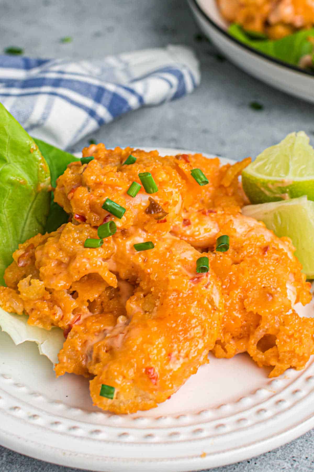 The recipe on a plate with lettuce and lime wedges.