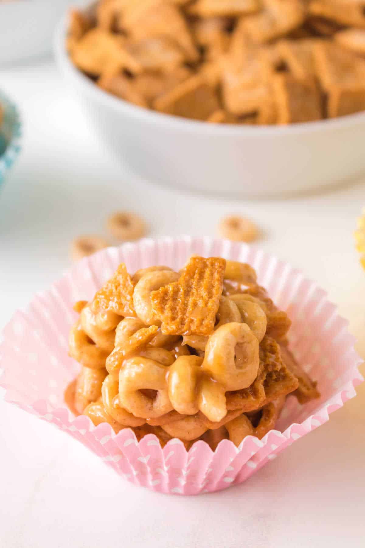 Peanut butter Cheerios Ball in a pink cupcake liner.