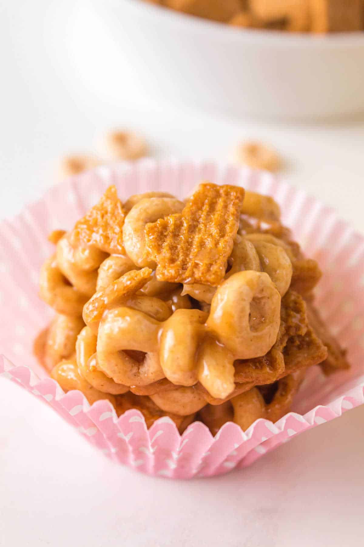 A peanut butter Cheerio ball in a pink cupcake liner.