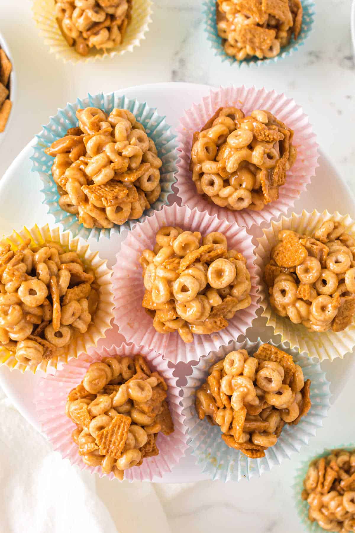 A group of peanut butter Cheerio balls on a plate.