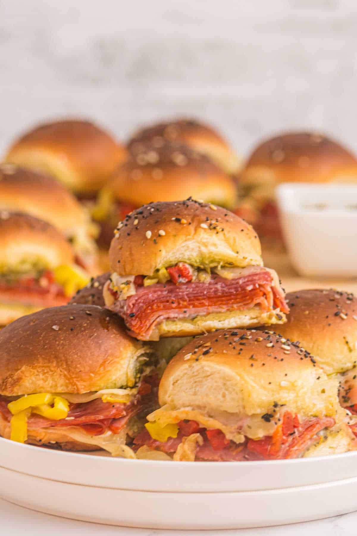 Italian sliders piled on a plate.