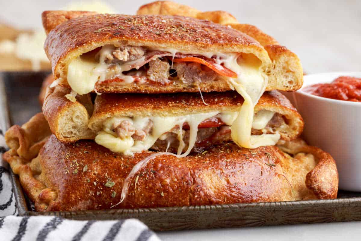 Meat calzone cut in half and piled on each other.
