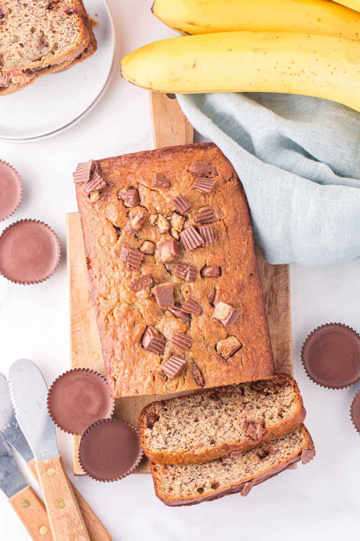 A loaf of Reese's peanut butter banana bread with two slices cut off the end.