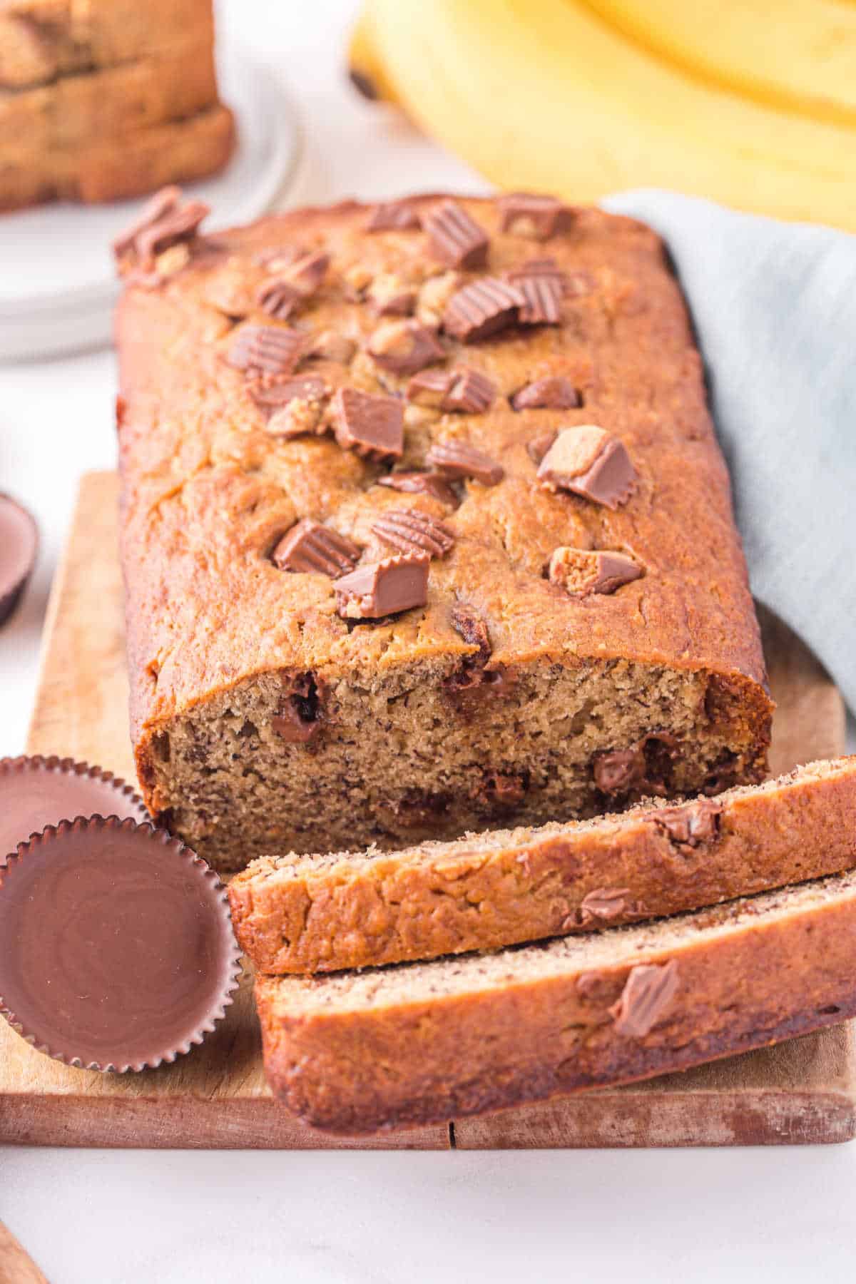 A loaf of Reese's peanut butter banana bread with a couple slices cut off the end.